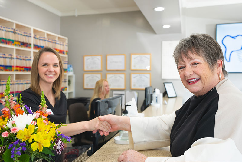 patient being helped at the front desk of the dental center